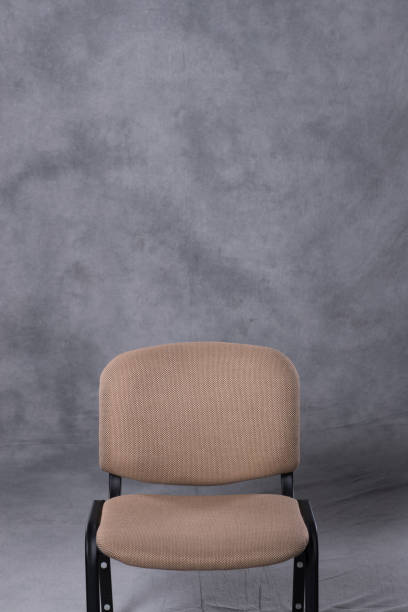 istock A chair in front of a tie dye pattern abstract background 983138896