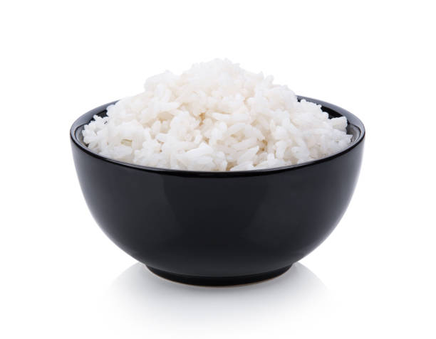 istock rice in black bowl on white background 983139072