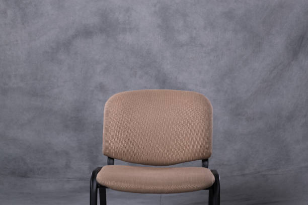 istock A chair in front of a tie dye pattern abstract background 983139078
