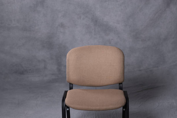 istock A chair in front of a tie dye pattern abstract background 983139170