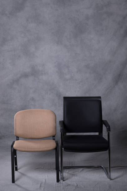 istock Two chairs in front of a tie dye pattern abstract background 983139174