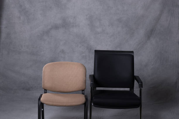 istock Two chairs in front of a tie dye pattern abstract background 983139308