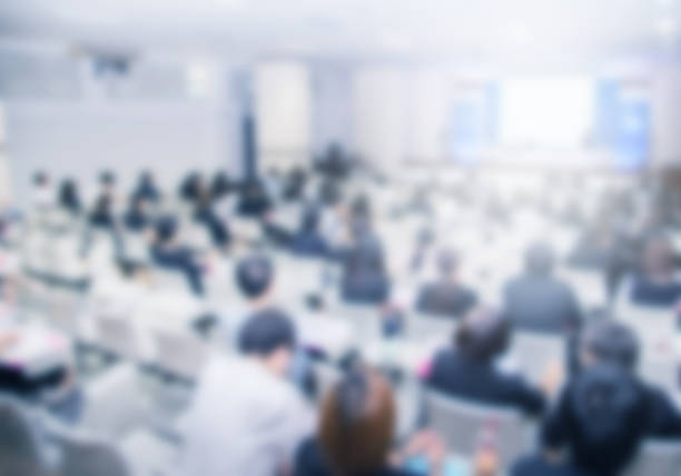 istock Microphone over the blurred business people forum Meeting Conference Training Learning Coaching Concept, Blurred background 983146798