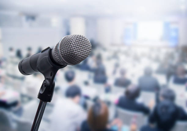 istock Microphone over the blurred business people forum Meeting Conference Training Learning Coaching Concept, Blurred background 983146808