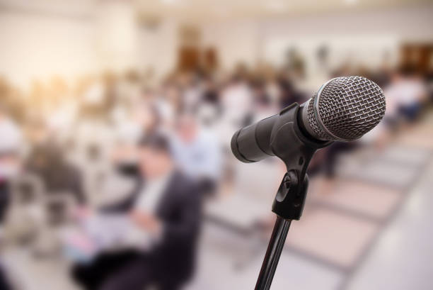 istock Microphone over the blurred business people forum Meeting Conference Training Learning Coaching Concept, Blurred background 983146822
