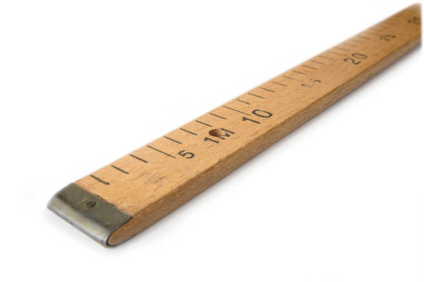 Close-up of tape measure on a blue background. Shallow depth of field, space for copy.