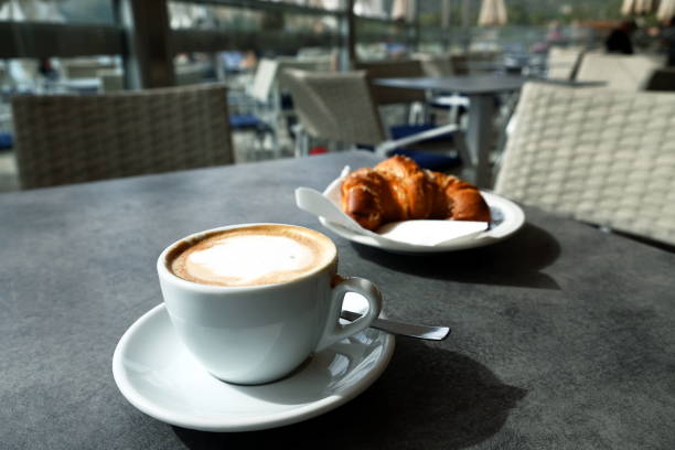 istock cup of cappuccino and croissant 983150404