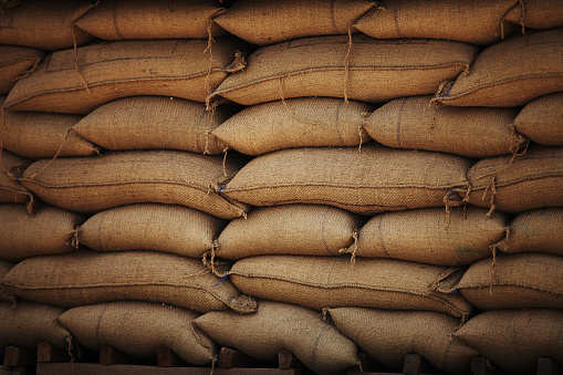 Grains in burlap bags in open market. The grain trade refers to the local and international trade in cereals and other food grains such as wheat, maize, and rice.