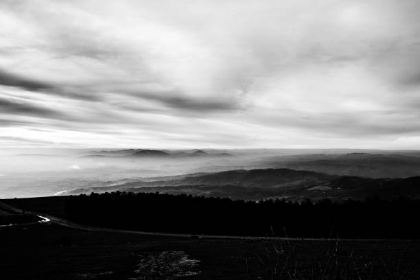 istock Subasio Mt. (Umbria, Italy), with sky covered by clouds and mist on the valley underneath 983166732