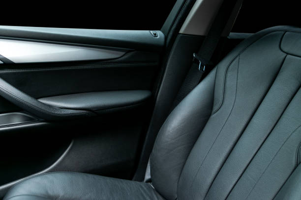 istock Car inside. Interior of a car. Comfortable leather Black seats. Black perforated leather. Car interior details. Car detailing 983166776