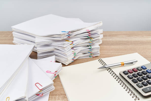 istock Pen on notebook with calculator white background and copy space 983176322