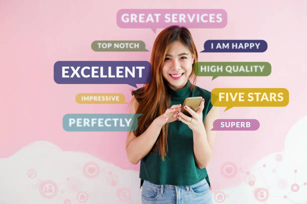 istock Customer Experience Concept. Happy Young Woman using Smart Phone to Read or Feedback her Satisfaction Online Survey. Surrounded by Social Icons and Positive Review in Speech Bubble 983177512