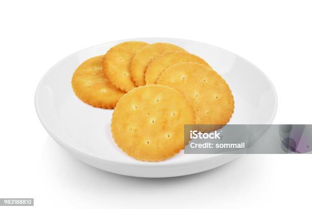 Cracker In Plate On White Background Stock Photo - Download Image Now - Appetizer, Backgrounds, Baked