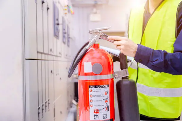 Photo of Engineer inspection Fire extinguisher in control room.