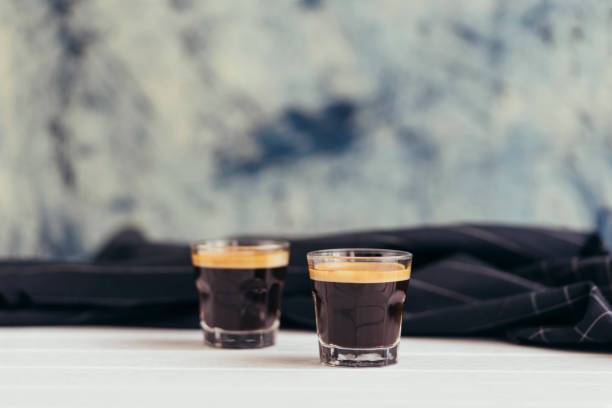 Two cups of espresso shot with crema