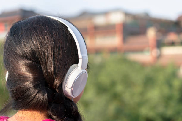 girl listening music on ancient city wall - ancient civilization audio imagens e fotografias de stock