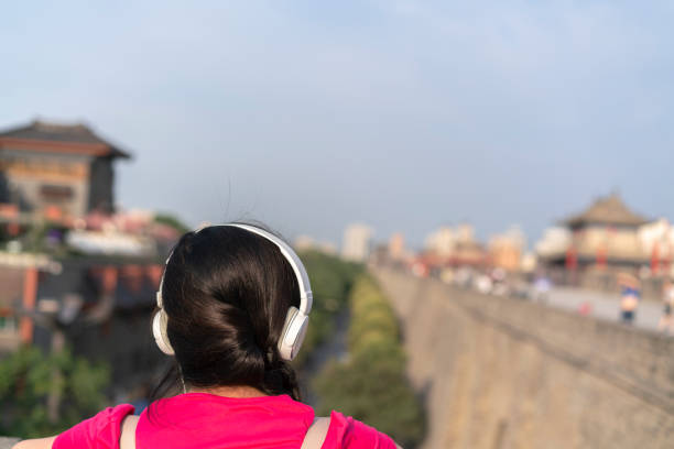 girl écoute musique sur la muraille de la ville antique - xian audio photos et images de collection
