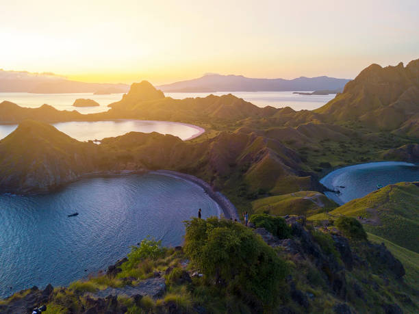 Panoramic view of majestic Padar Island during magnificent sunset. Soft focus and Noise slightly appear due to high iso. Panoramic view of majestic Padar Island during magnificent sunset. Soft focus and Noise slightly appear due to high iso pulau komodo stock pictures, royalty-free photos & images