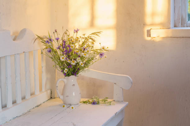 istock wild flowers in jug on white wooden bench 983214620