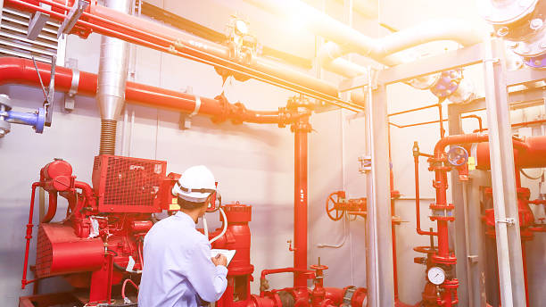 istock Engineer check red generator pump for water sprinkler piping and fire alarm control system. 983219524