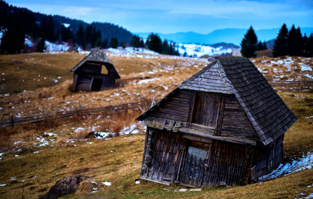 abstract shot of wooden barn on the hill in winter day.