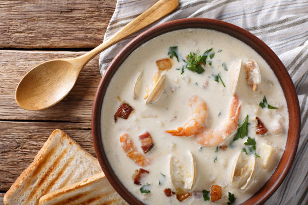 istock American food: New England clam chowder soup close-up on a in a bowl. horizontal top view 983240048
