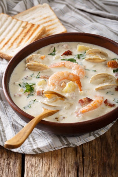 istock American food: New England clam chowder soup close-up on a in a bowl. vertical 983240148
