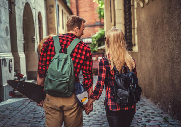 istock Loanboarders couple from their back. 983240568