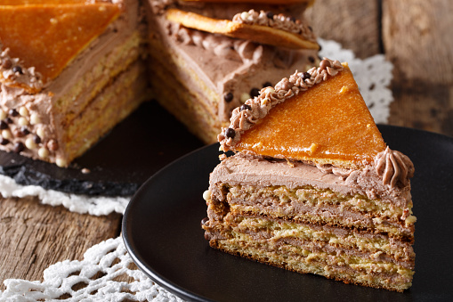 Delicious slice of Hungarian Dobosh cake with caramel close-up on a plate. horizontal