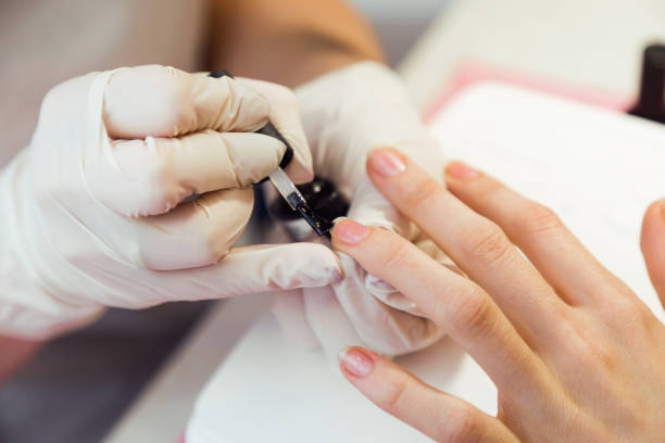 istock Young woman doing manicure in salon. Beauty concept. 983240884