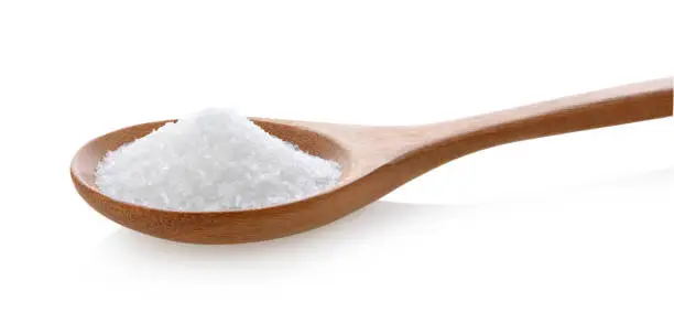 monosodium glutamate in wood spoon on white background