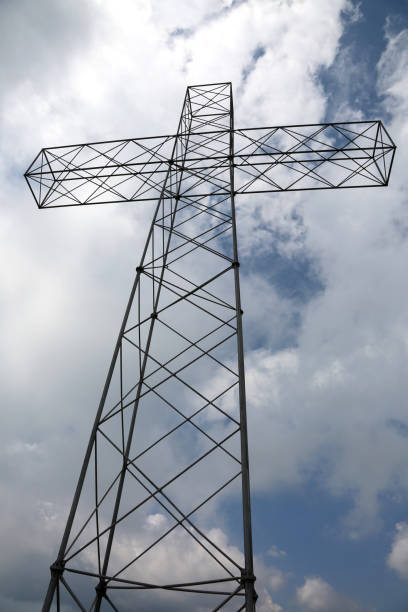 istock big cross in vertical and many clouds 983244582