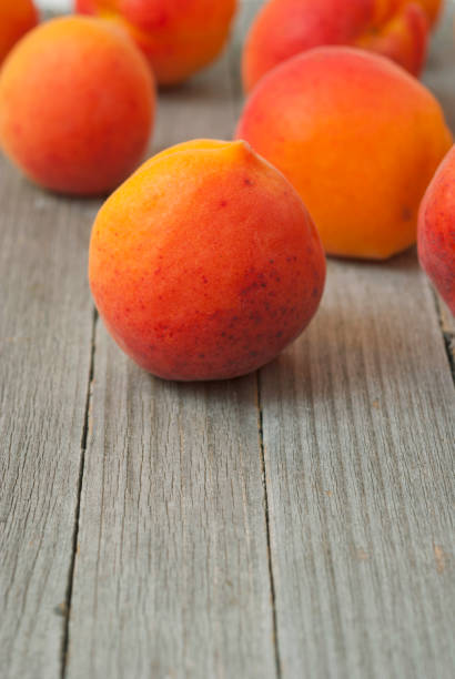 istock Peaches on weathered wooden table 983245438