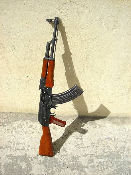 AK-47 against a wall stock photo