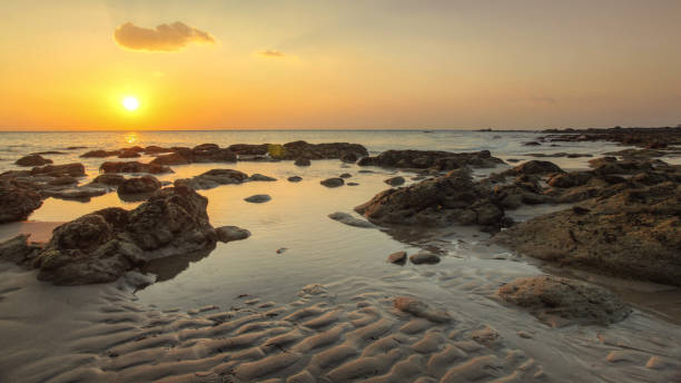 istock Beach in golden sunset light during low tide showing sand formations and rocks not covered by the sea. Kantiang Bay, Ko Lanta, Thailand. 983252120