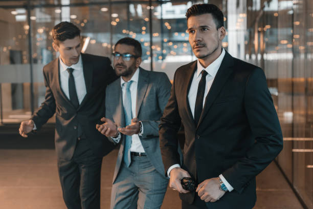 istock two security guards going with criminal in business center 983263072