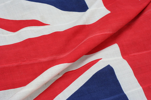 British flag. Macro photography of flag. The United Kingdom of Great Britain and Northern Ireland. Red, Blue, White