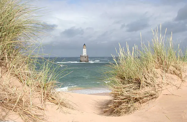 Photo of Scottish lightouse in sea on windy, stormy day