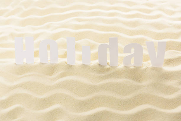 Word Holiday on sandy beach waves