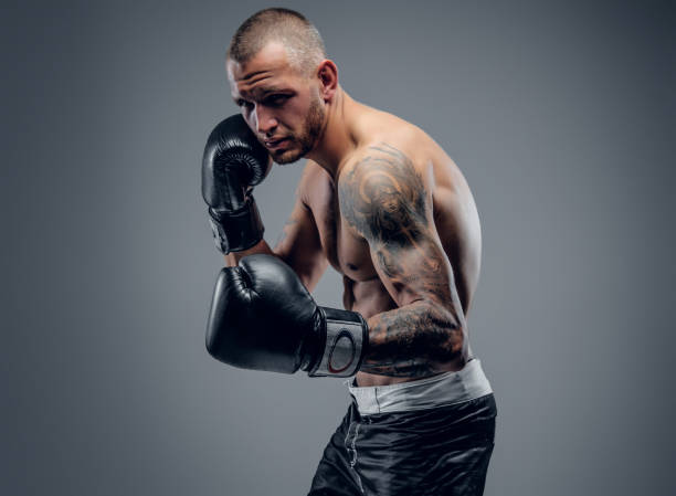 istock Brutal extreme fighter with tattoo on arms 983285002