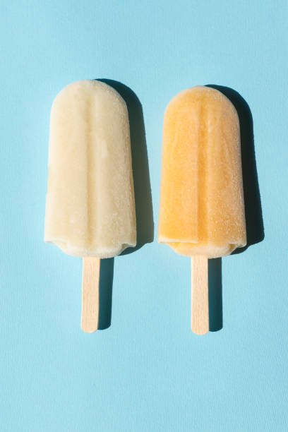 istock Lemon and milk popsicles on a turquoise background 983288484