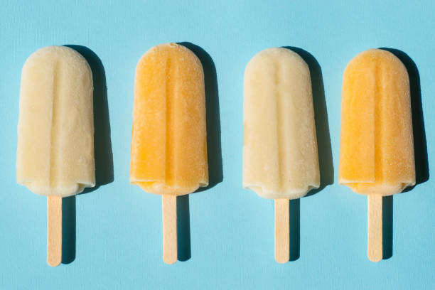 istock Lemon and milk popsicles on a turquoise background 983288532
