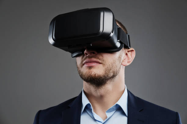istock Male in a suit with virtual reality glasses on his head. 983288654