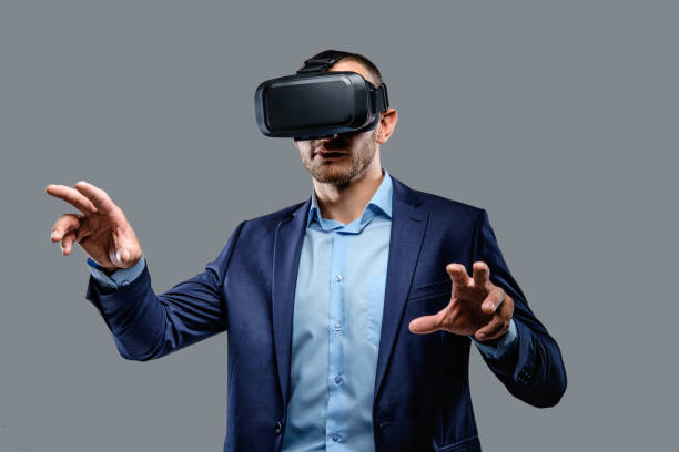 istock Male in a suit with virtual reality glasses on his head. 983289120
