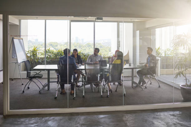 istock Business people discussing in board room at office 983289154