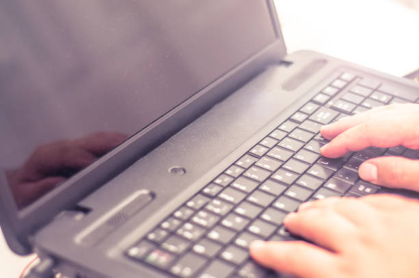 istock Man hands typing on a laptop keyboard on a desk 983291446