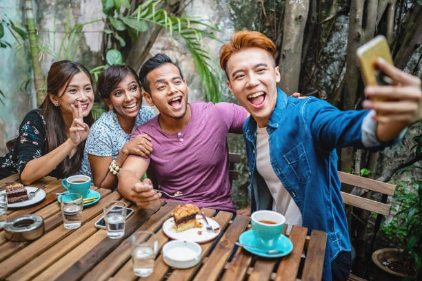 istock Malaysian Students Shooting Selfies in Cafe 983292748
