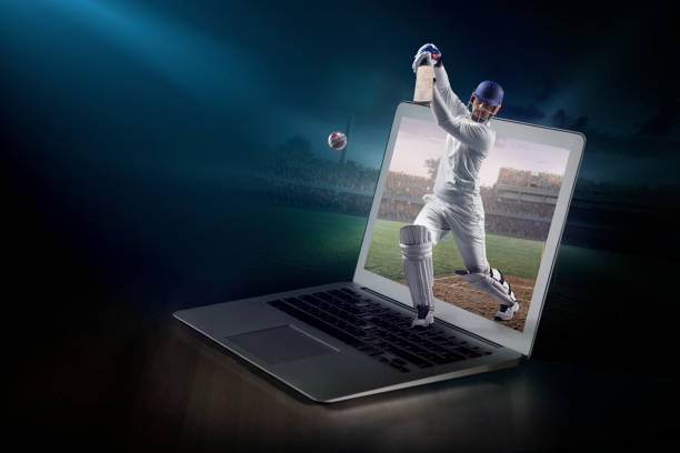 istock Cricket on laptop. Live broadcast 983304784