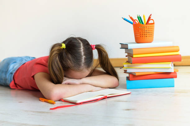 istock Difficulties in study. The tired child doesn't want to study. A stress in training 983305564