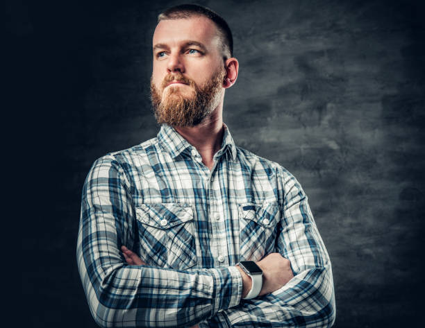 istock Bearded male dressed in a fleece shirt over grey background. 983308816